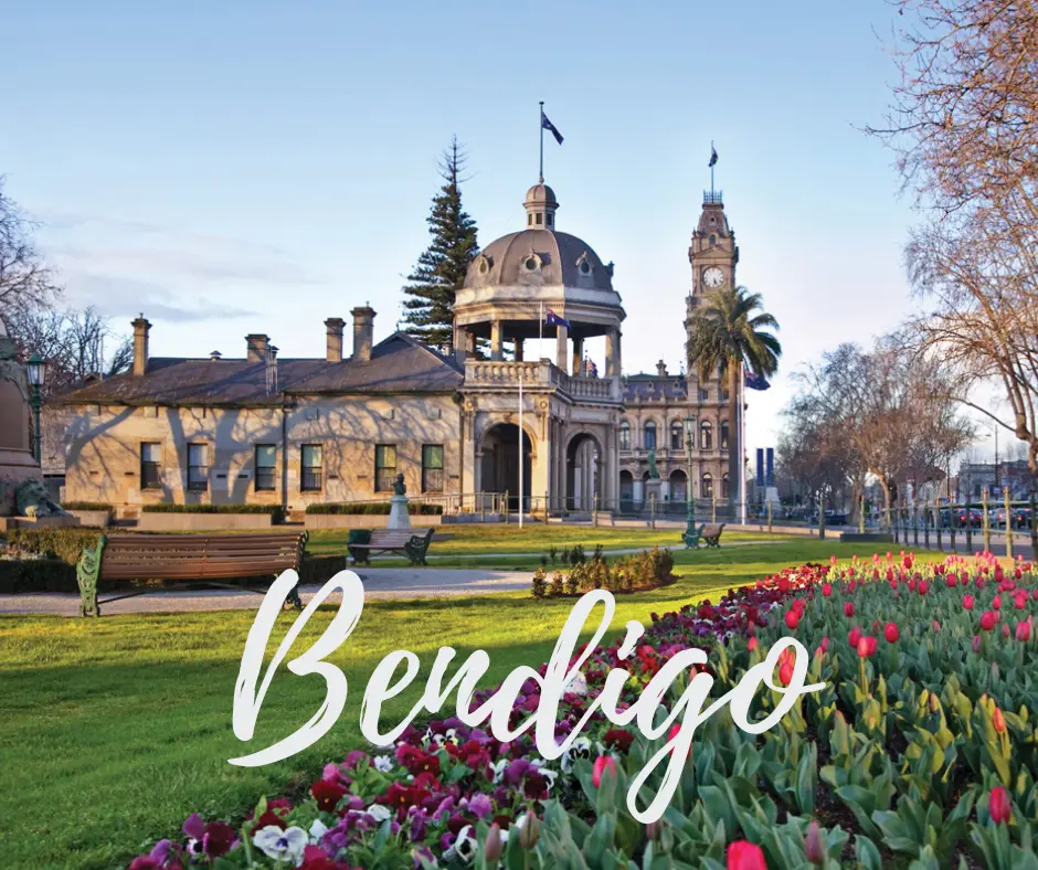 The historic Bendigo Town Hall and Conservatory Gardens in Rosalind Park, Victoria, framed by colourful tulip beds.