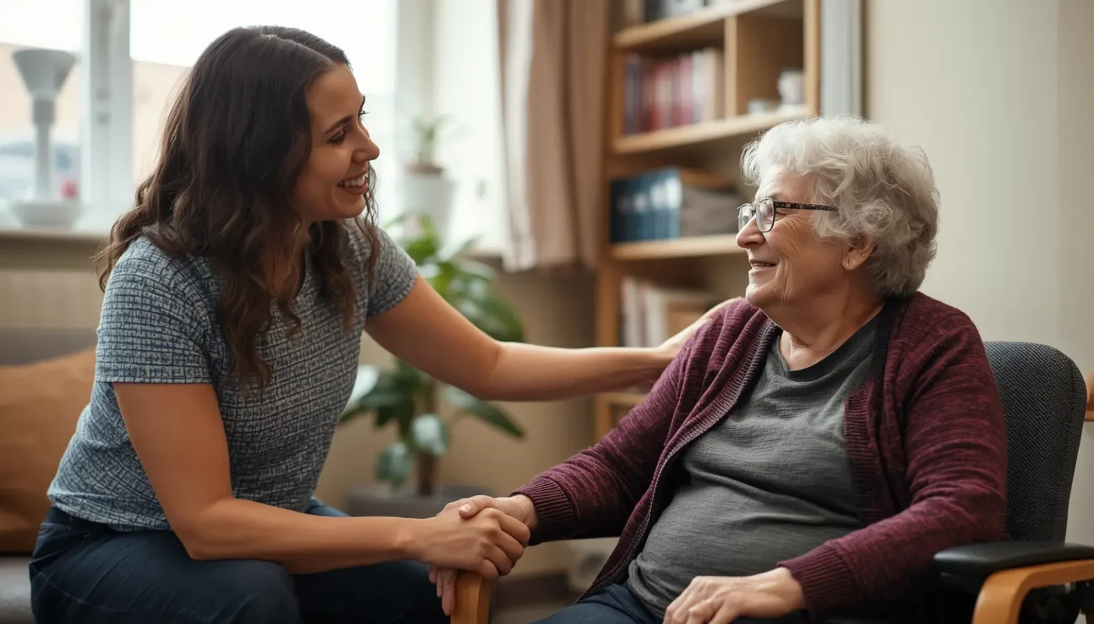 A friendly occupational therapist smiling warmly and holding the hand of an elderly female client during a comfortable home visit.